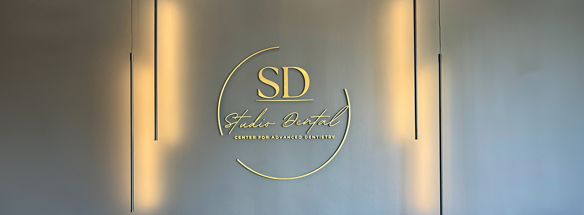 The image shows a sign with text on it, which appears to be an advertisement or promotional material for a business named  S.D.  The sign has a modern design with a backlit display panel featuring the name and possibly other information in a stylized font.