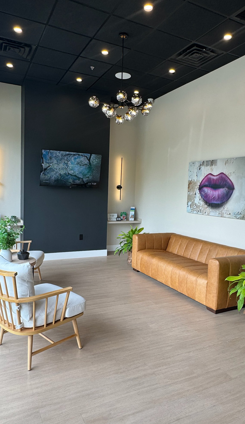 The image shows a modern dental or medical office interior with a dental chair, equipment, and a clean, professional environment.